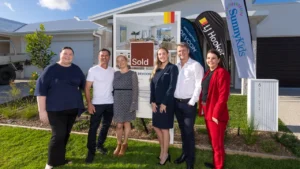 (L-R) Kathleen Hope - CEO, SunnyKids , Lorenzo and Amanda - happy buyers, Sarah Cain and Michael Cain - Devcon Property Group; Jodi Price, Principal, LJ Hooker Mooloolaba | Mountain Creek. Image Supplied