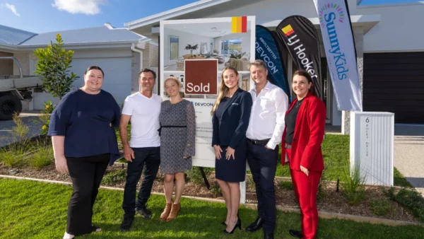 (L-R) Kathleen Hope - CEO, SunnyKids , Lorenzo and Amanda - happy buyers, Sarah Cain and Michael Cain - Devcon Property Group; Jodi Price, Principal, LJ Hooker Mooloolaba | Mountain Creek. Image Supplied
