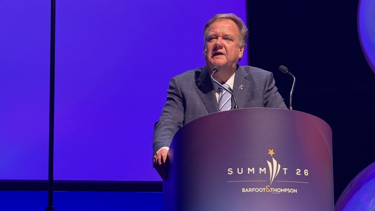 Barfoot & Thompson Managing Director Peter Thompson speaking at a lectern branded Summit 26 in Auckland