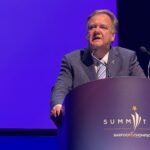 Barfoot & Thompson Managing Director Peter Thompson speaking at a lectern branded Summit 26 in Auckland