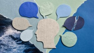 Hand-cut paper collage of seven speech bubbles in blues and greens around a newsprint silhouette head, one bubble torn in half