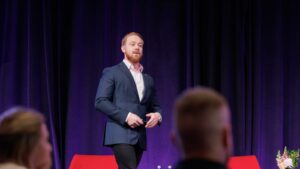 Naaman Fraser speaking at PM/ONE 2026