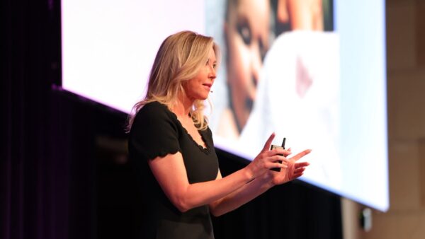 Chelsea Pottenger speaking at PM/ONE 2026