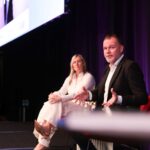 Pamela Medeiros and Bradley Fraser speaking at PM/ONE 2026
