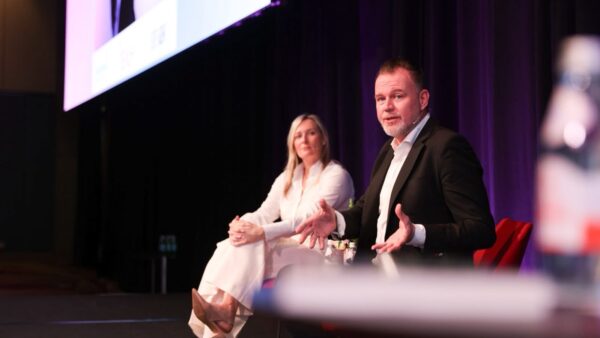 Pamela Medeiros and Bradley Fraser speaking at PM/ONE 2026